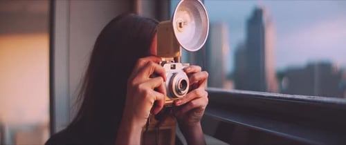 Woman Photographer with Vintage Camera in Golden Hour