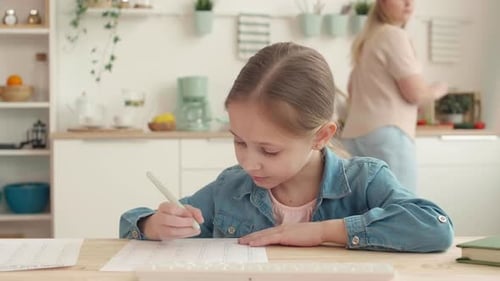 Girl Doing Homework in a Bright Kitchen