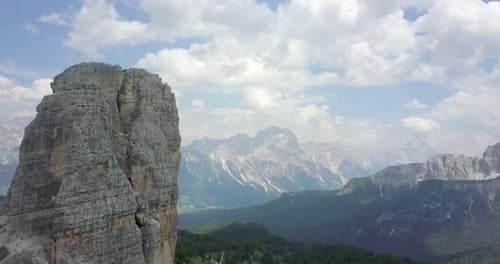 Aerial drone view of a man and woman couple mountain climbing on top of a tower.