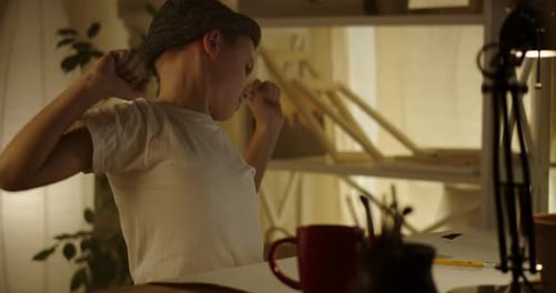 Boy Concentrating on Drawing at Desk