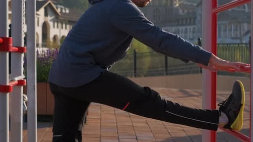 Sporty Young Man Stretching Muscles Before Jogging
