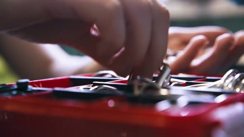 Close up of hands selecting small scissors