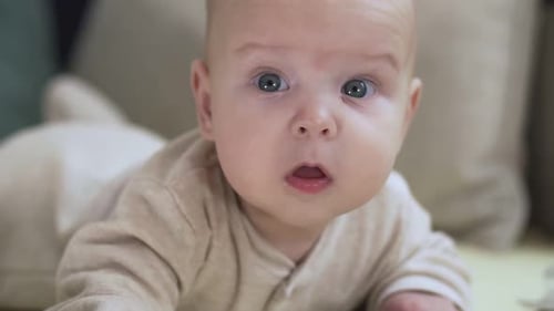 Close Up of Baby Lying on Bed. Childhood, Babyhood and People Concept