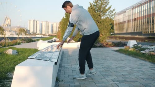 Young Adult Doing Push-ups on Park Bench