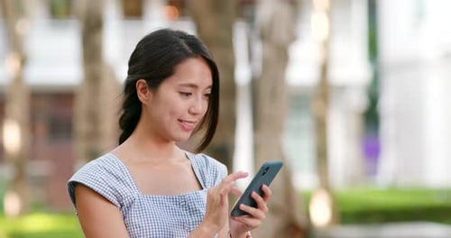 Woman Using Mobile Phone in Urban Environment