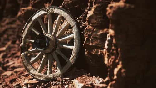 Old Wooden Cart Wheel on Stone Rocks