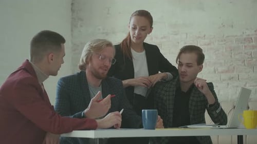Business Woman Talking with Her Colleagues in the Office and Showing Them Documents.