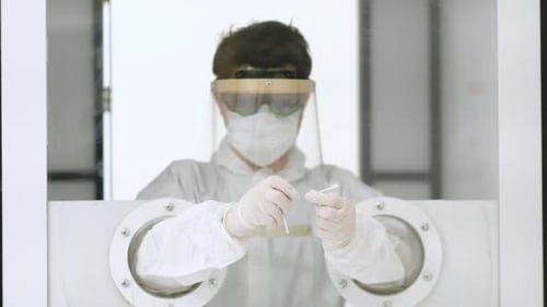 Lab Worker Handling Swab in Protective Gear
