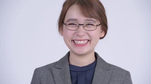 Smiling Woman Wearing Glasses and a Gray Blazer
