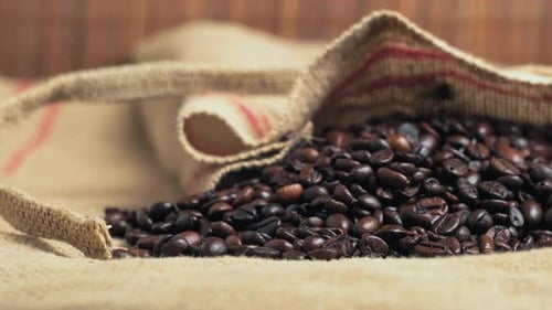 Coffee Beans Overflowing From a Rustic Burlap Sack