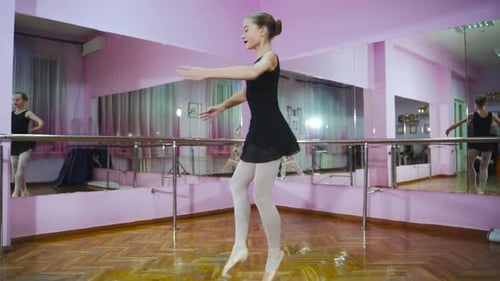 Ballerina. Girl dancer in ballet school learns to dance. Slow motion