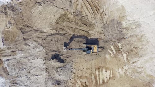 Excavator Digging in Rural Location From Above
