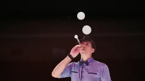 Adult Juggler Performs Magic With Bubbles and Balls