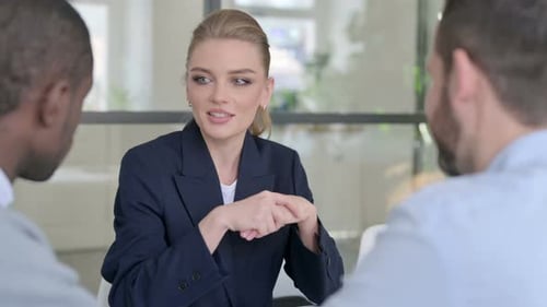 Businesswoman in Meeting with Colleagues in Office
