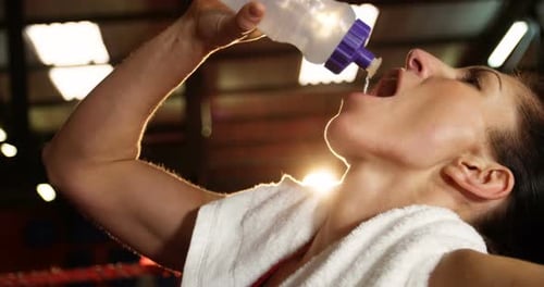 Woman Hydrating After Workout at the Gym