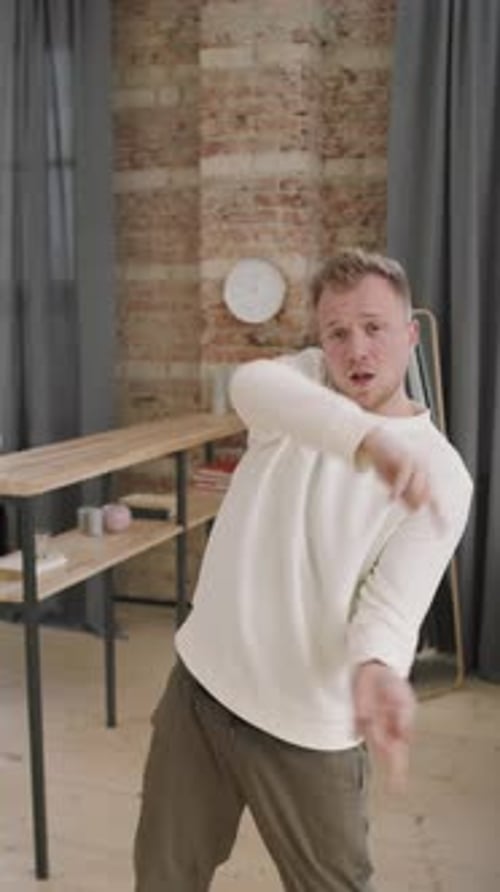 Man Improvising to Music before Camera