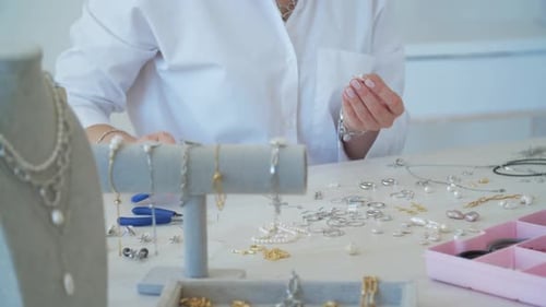 Jewelry Maker Assembling Silver and Pearl Pieces