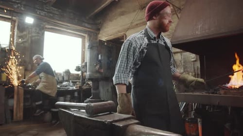 Blacksmith at Work Shaping Metal on Anvil
