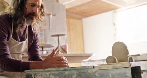 Potter Shaping Clay on a Wheel Indoors