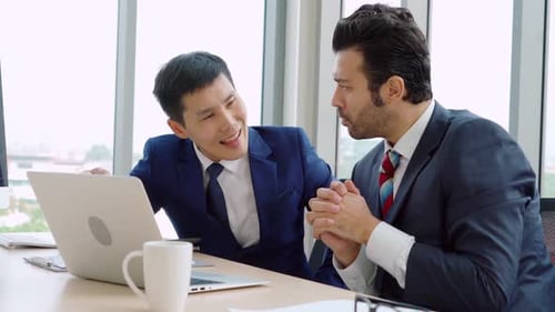 Two Business People Talk Project Strategy at Office