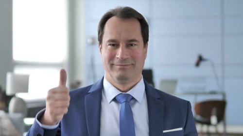 Professional Man Smiling and Giving Thumbs Up