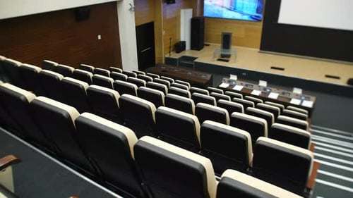 Empty Lecture Hall Interior with Seats and Stage