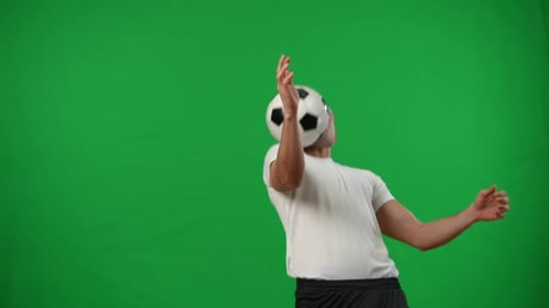 Man Performs Soccer Header in Front of Green Screen