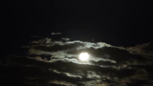 Clouds Passing Over Full Moon at Night