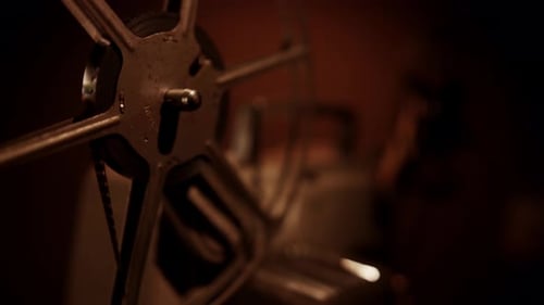 Vintage Film Projector Rolling in Dramatic Darkness