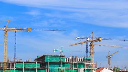 Towering Cranes at Construction Site in City