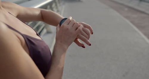 Woman Using Smart Watch on City Street