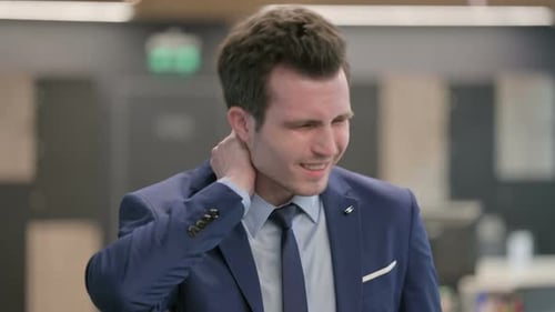 Man Suffering Neck Pain in an Office Setting