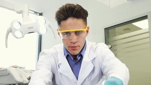 Professional Dentist Working at His Clinic