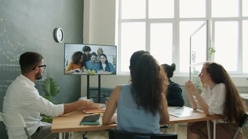 Multiethnic Business Group Negotiating Through Video Call Using Digital Screen in Office
