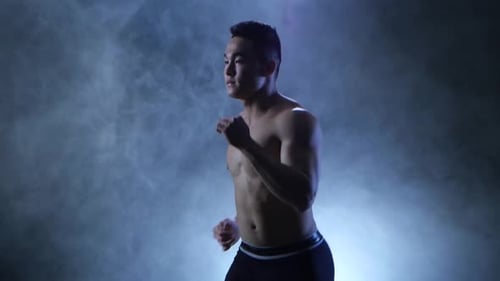 Sportsman Run on Black Background in Smoky Studio. Muscular Body