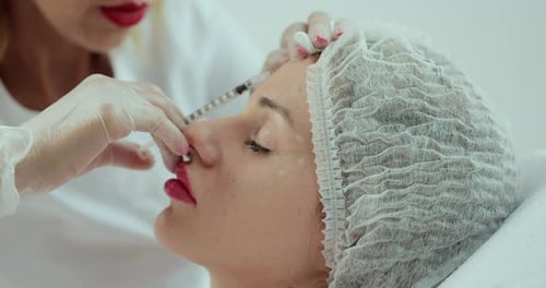 Woman Receives Cosmetic Injection in Clinic