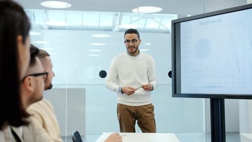 Middle Eastern Young Man Giving Lecture About Finance in Office Conference Hall