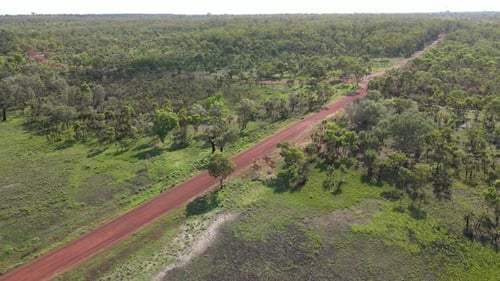 Slow moving drone shot of Red Road and Green Bushland near Holmes Jungle Nature Park, Darwin, Northe
