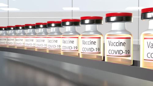COVID-19 Vaccine Vials Moving on a Sterile Production Line