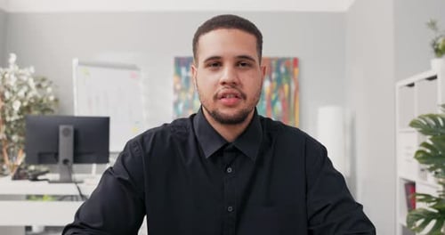 Young Adult Speaking in Modern Office Environment