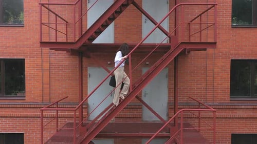 Businesswoman Climbing Up the Stairs of a Business Centre