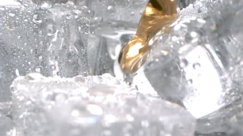Pouring Liquid onto Ice Cubes Close-up