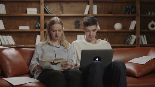 Young Man and Woman Reading and Studying Together