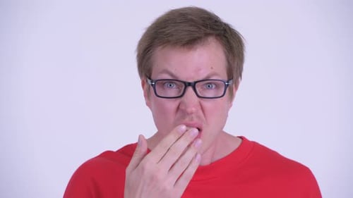 Man Reacts with Surprise, Hand Covering Mouth
