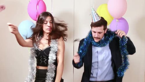 Funny couple playing with props in photo booth
