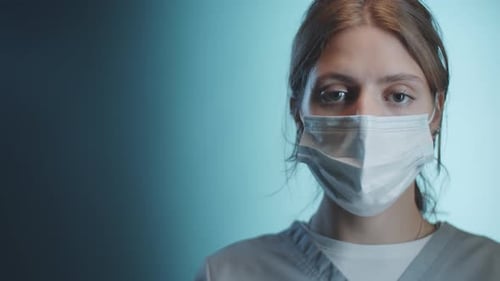 Studio Portrait of Young Female Doctor in Medical Mask