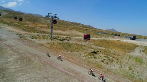 Cyclists Mountain Biking on a Rural Mountainside Trail