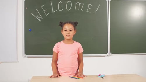 African Schoolgirl Looking Globe with Chalk Background