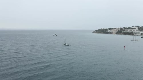Sailboat Moving By The Waves At Palma Bay With Foggy Horizon In Majorca Island Spain