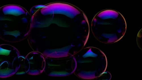Soap bubbles floating in dark room